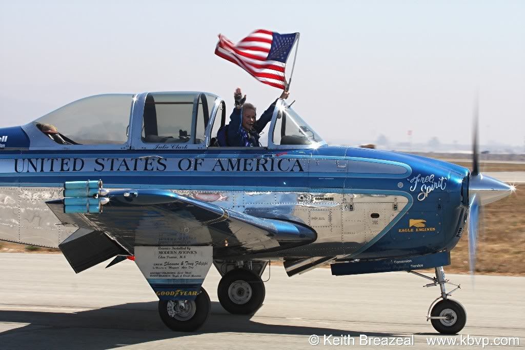 IMAGE: http://i197.photobucket.com/albums/aa5/KBVP/JulieClarktaxiwithflagandwave.jpg